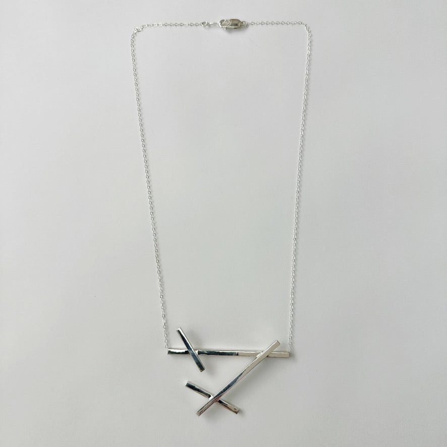 Criss cross store necklace